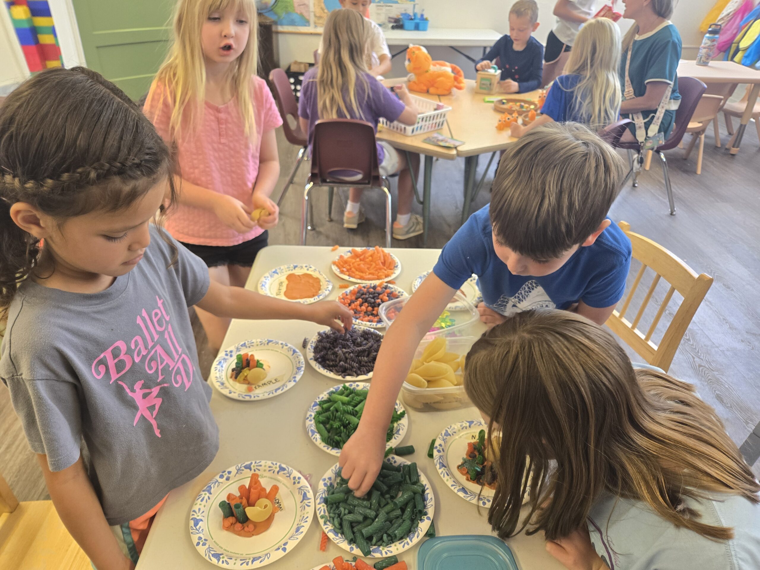students sharing and engaging in activity at a table